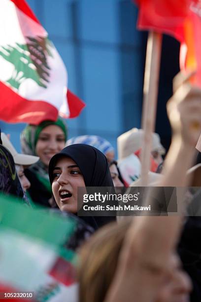 Lebanese people welcome Iranian President Mahmoud Ahmadinejad as he arrives in southern suberb of Beirut on October 13, 2010 in Lebanon. The...