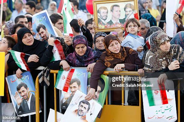 Lebanese people welcome Iranian President Mahmoud Ahmadinejad as he arrives in southern suberb of Beirut on October 13, 2010 in Lebanon. The...