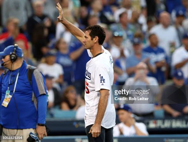 Former player Sean Green of the Los Angeles Dodgers waves before throwing out the ceremonial first pitch before Game 4 of the NLCS against the...