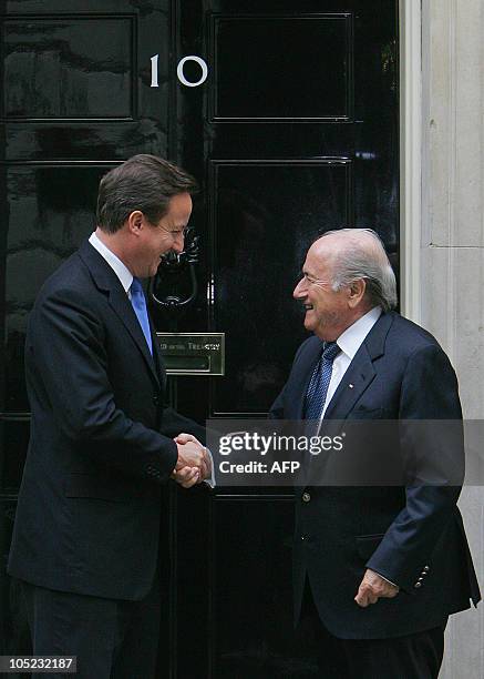 British Prime Minister David Cameron , shakes hands with FIFA President Sepp Blatter as he greets him on the steps of 10 Downing Street in central...