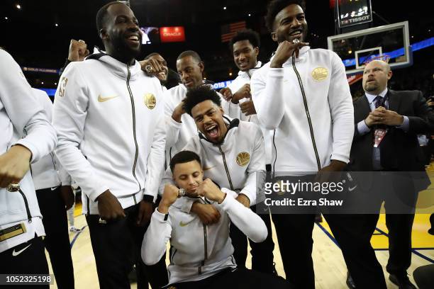 Stephen Curry and the Golden State Warriors celebrate after receiving their 2017-2018 Championship rings prior to their game against the Oklahoma...