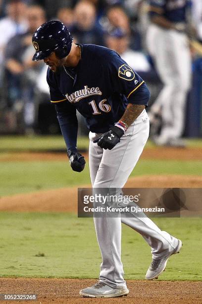 Domingo Santana of the Milwaukee Brewers reacts after hitting a RBI double off Rich Hill of the Los Angeles Dodgers during the fifth inning in Game...