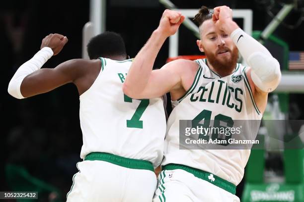 Jaylen Brown reacts with Aron Baynes of the Boston Celtics during a game against the Philadelphia 76ers at TD Garden on October 16, 2018 in Boston,...