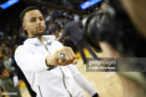 Stephen Curry of the Golden State Warriors shows his 2017-2018 Championship ring prior to their game against the Oklahoma City Thunder at ORACLE...