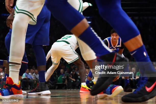 Markelle Fultz of the Philadelphia 76ers dribbles the ball while guarded by Terry Rozier of the Boston Celtics during a game at TD Garden on October...