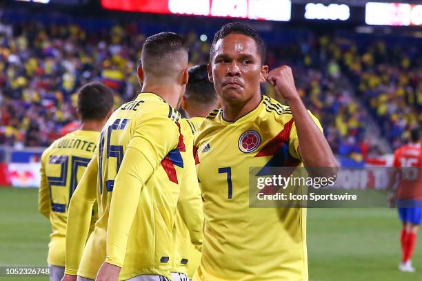 Colombia forward Carlos Bacca celebrates with teammate Colombia midfielder James Rodriguez after scoring during the first half of the International...