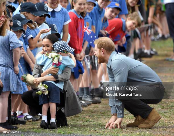 Prince Harry, Duke of Sussex and Meghan, Duchess of Sussex arrive at Dubbo airport and is greeted by 5 year old Luke Vincent on October 17, 2018 in...