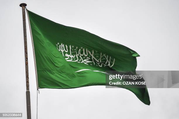 Saudi Arabian flag flies over the consulate building in Istanbul on October 17, 2018. - Saudi Arabia's consul to Istanbul Mohammed al-Otaibion on...
