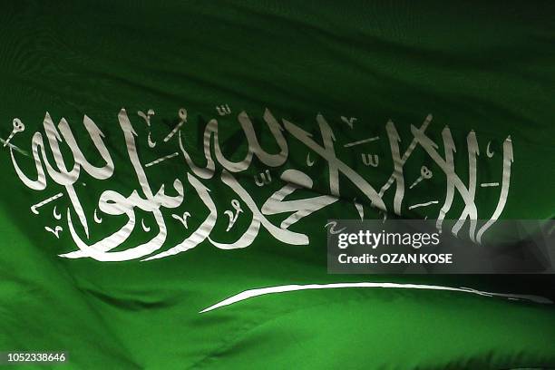 Saudi Arabian flag flies over the consulate building in Istanbul on October 17, 2018. - Saudi Arabia's consul to Istanbul Mohammed al-Otaibion on...