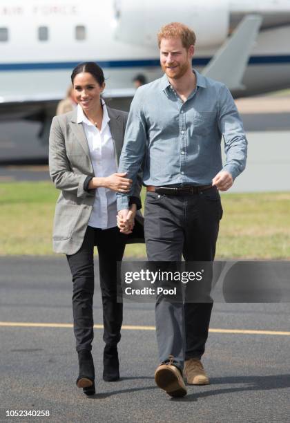 Prince Harry, Duke of Sussex and Meghan, Duchess of Sussex arrive at Dubbo Airport on October 17, 2018 in Dubbo, Australia. The Duke and Duchess of...