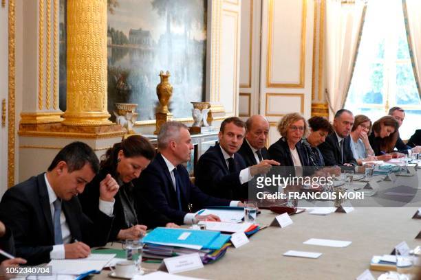 French President Emmanuel Macron gestures as he chairs the weekly cabinet meeting at the Elysee Palace, on October 17 in Paris. - Macron made a rare...