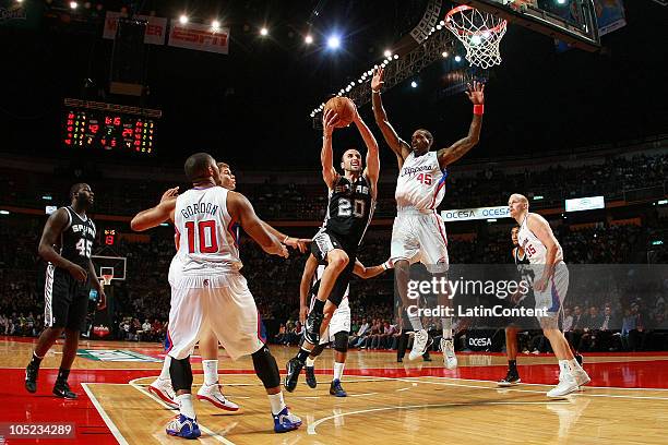 Manu Ginobili of the San Antonio Spurs drives against Rasual Butler of the Los Angeles Clippers during a preseason game on October 12, 2010 at the...