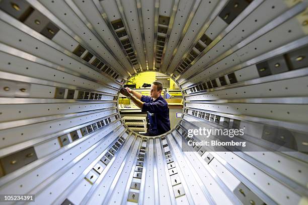 Ferry Fleskens, a technician, works on a MRI scanner at the Philips Healthcare production facility in Best, Netherlands, on Tuesday, Oct. 12, 2010....