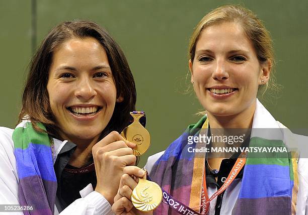 New Zealand's Joelle King and Jaclyn Hawke pose with their gold medals during the squash women's doubles awards ceremony at the Siri Fort Sports...