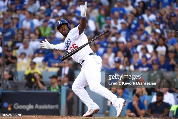 Yasiel Puig of the Los Angeles Dodgers reacts after hitting a RBI single in the sixth inning against the Milwaukee Brewers in Game Five of the...