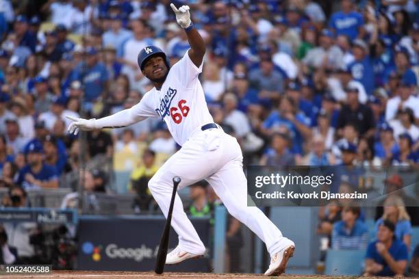 Yasiel Puig of the Los Angeles Dodgers reacts after hitting a RBI single in the sixth inning against the Milwaukee Brewers in Game Five of the...