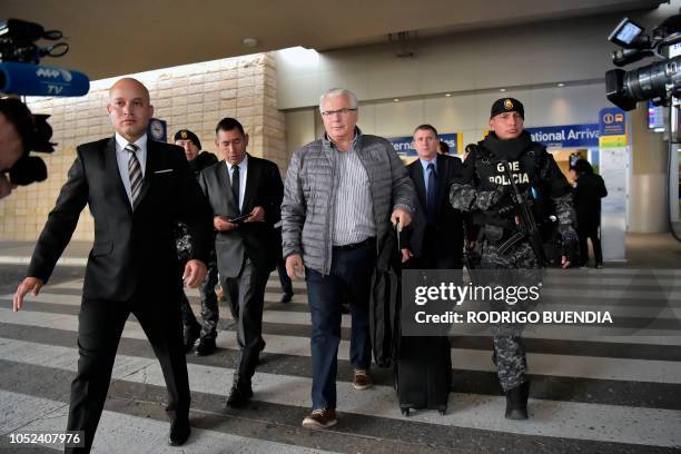 Spanish former judge Baltasar Garzon , lawyer of Wikileaks founder Julian Assange, is escorted after arriving at Mariscal Sucre international airport...