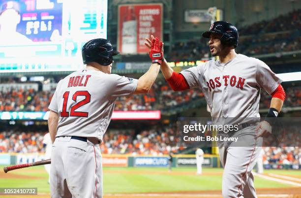 Martinez of the Boston Red Sox celebrates with Brock Holt after scoring a run in the first inning against the Houston Astros during Game Four of the...