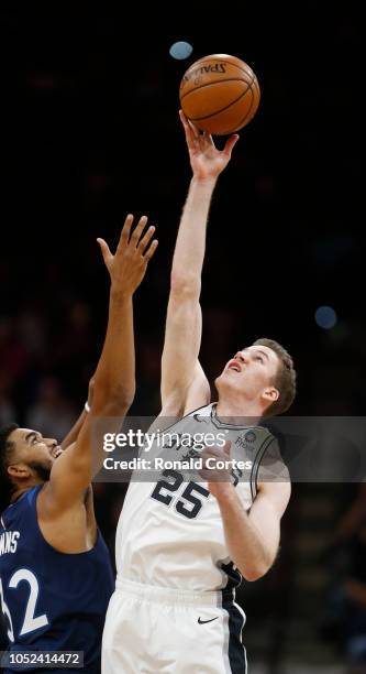 Jakob Poeltl of the San Antonio Spurs outumps Karl-Anthony Towns of the Minnesota Timberwolves in opening tip off in season opener at AT&T Center on...