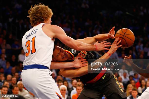 Jeremy Lin of the Atlanta Hawks and Ron Baker of the New York Knicks battle for the ball at Madison Square Garden on October 17, 2018 in New York...