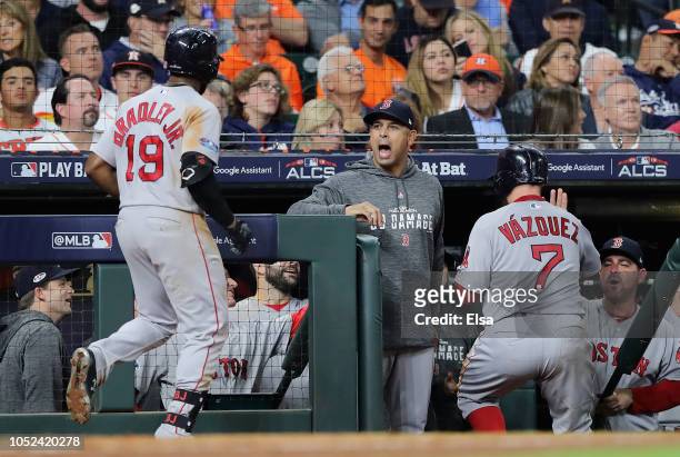 Jackie Bradley Jr. #19 of the Boston Red Sox celebrates at the dugout with manager Alex Cora after hitting a two-run home run in the sixth inning...