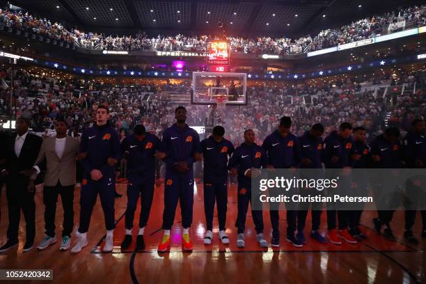 The Phoenix Suns stand attended for the national anthem before the NBA game against the Dallas Mavericks at Talking Stick Resort Arena on October 17,...