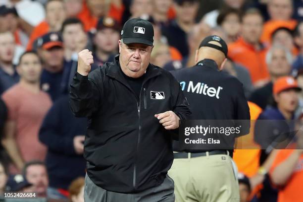 Umpire Joe West calls out Jose Altuve of the Houston Astros , on fan interference in the first inning during Game Four of the American League...