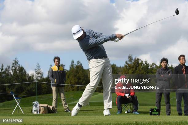 Chez Reavie of the US tees off on the ninth hole during the first round of the CJ Cup golf tournament at Nine Bridges golf club in Jeju Island on...