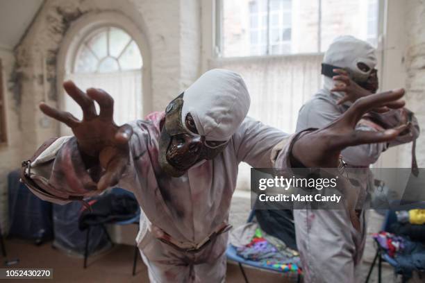 Cast members get ready ahead of a dress rehearsal of the Circus of Horrors' latest show Psycho Asylum, ahead of Halloween, at the Wookey Hole Caves...