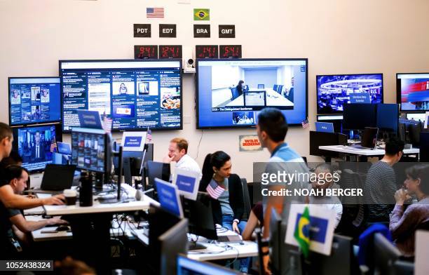 Employees work in Facebook's "War Room," during a media demonstration on October 17 in Menlo Park, California. The freshly launched unit at...