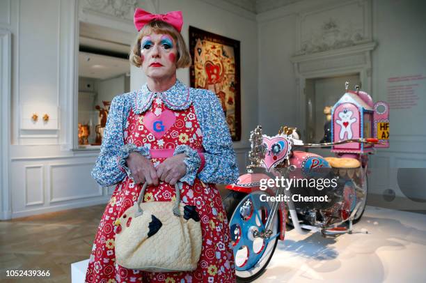 British artist Grayson Perry poses in front of his art work "Kenilworth AM1 2010", a customised motorcycle during a press visit of his exhibition...