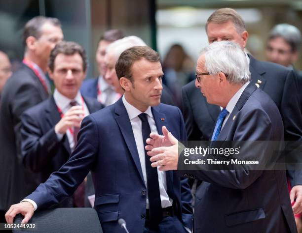 French President Emmanuel Macron is talking with the President of the European Commission Jean-Claude Juncker during an EU chief of state summit in...