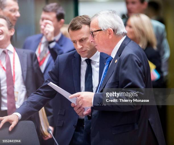 French President Emmanuel Macron is looking at papers with the President of the European Commission Jean-Claude Juncker during an EU chief of state...