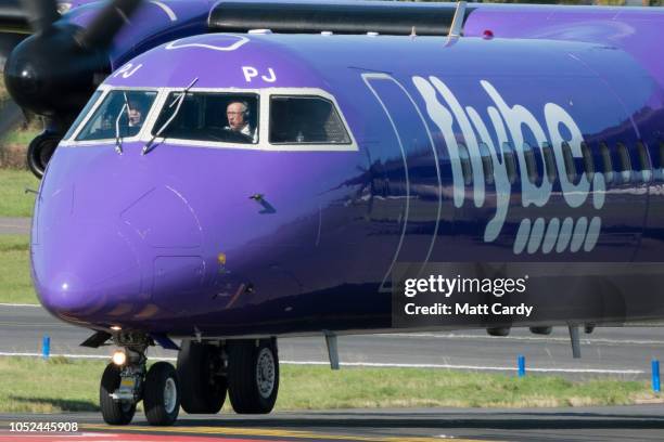 Aircraft operated by the airline Flybe, taxis down the runway at Exeter Airport near Exeter on October 18, 2018 in Devon, England. The value of...