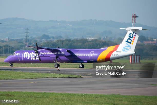 Aircraft operated by the airline Flybe, taxis down the runway at Exeter Airport near Exeter on October 18, 2018 in Devon, England. The value of...