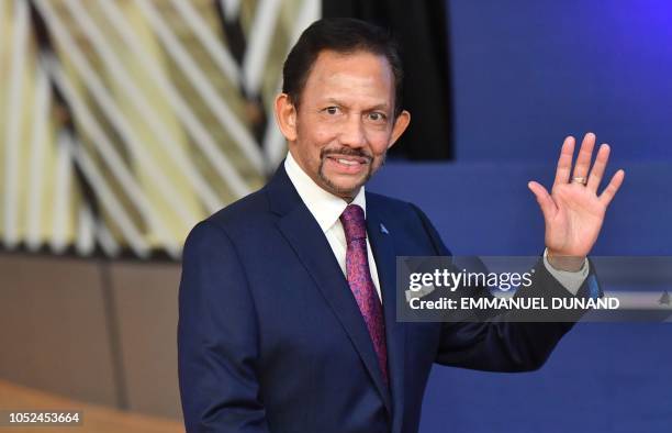 Sultan of Brunei Haji Hassanal Bolkiah waves as he arrives for a Asia Europe Meeting at the European Council in Brussels on October 18, 2018.