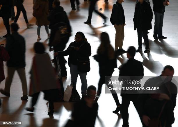 Silhouette's of commuters and tourists as they make their way through Grand Central Terminal in New York City during the morning rush hour October...