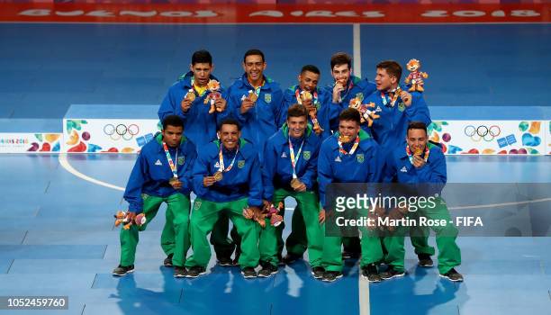The team of Brazil celebrate winning the gold medal in the Men's Futsal Final match between Brazil and Russia during the Buenos Aires Youth Olympics...