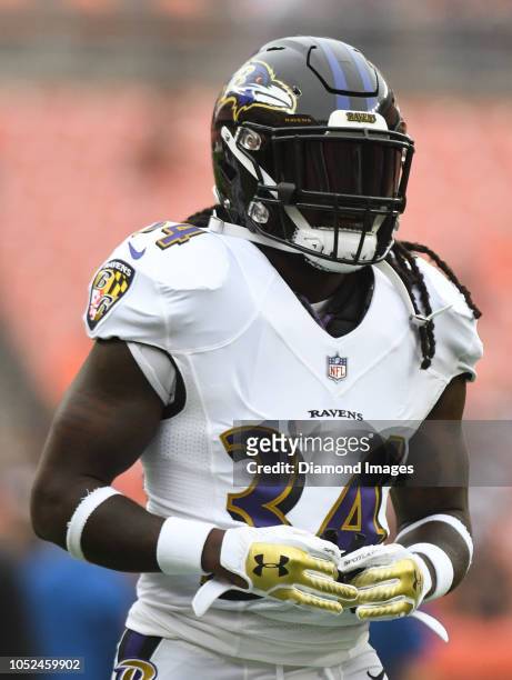 Running back Alex Collins of the Baltimore Ravens on the field prior to a game against the Cleveland Browns on October 7, 2018 at FirstEnergy Stadium...