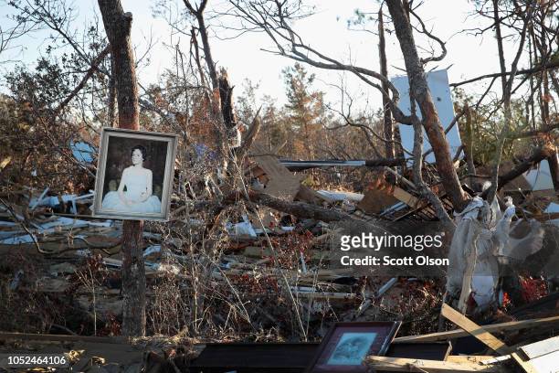 Piece of art hangs on a tree in a wooded area strewn with debris on October 18, 2018 in Mexico Beach, Florida. Hurricane Michael slammed into the...