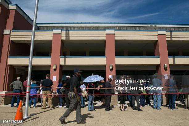 Voters wait in line for up to two hours to early vote at the Cobb County West Park Government Center on October 18, 2018 in Marietta, Georgia. Early...