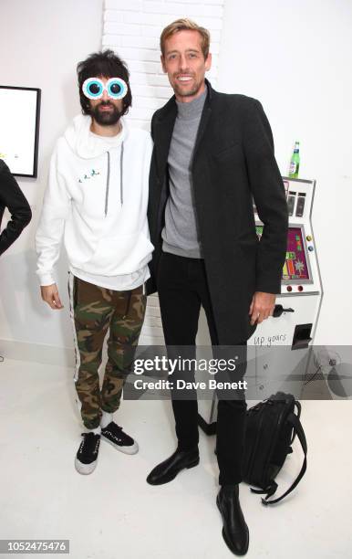 Serge Pizzorno and Peter Crouch attend a private view of "Daft Apeth" by Serge Pizzorno of Kasabian at No Ho Showrooms on October 18, 2018 in London,...