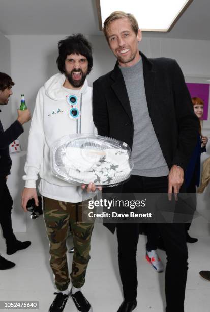 Sergio Pizzorno and Peter Crouch attend a private view of "Daft Apeth" by Serge Pizzorno of Kasabian at No Ho Showrooms on October 18, 2018 in...