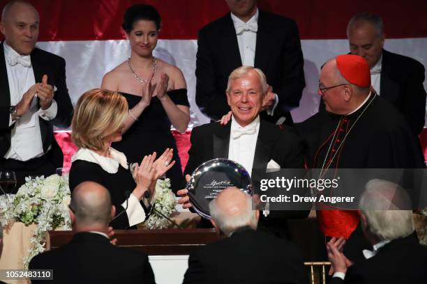 Lowell McAdam , former CEO of Verizon, is awarded with the 'Happy Warrior Award' from Archbishop of New York Cardinal Timothy Dolan at the annual...