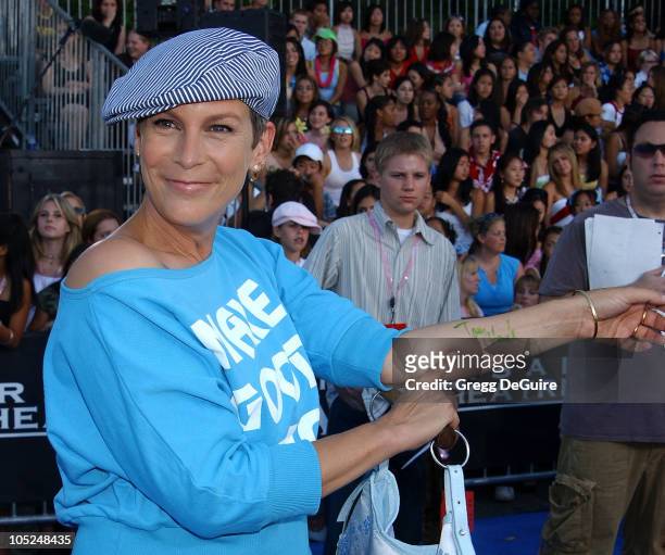 Jamie Lee Curtis pointing to her "Tony Hawk" autograph he signed on her forearm