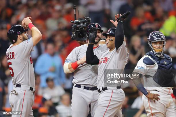 Rafael Devers of the Boston Red Sox celebrates with teammates after hitting a three-run home run in the sixth inning against the Houston Astros...