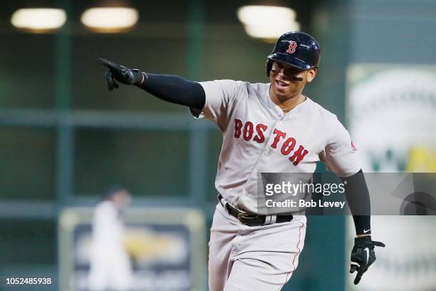Rafael Devers of the Boston Red Sox celebrates as he runs the bases after hitting a three-run home run in the sixth inning against the Houston Astros...