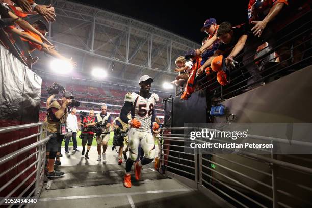 Linebacker Von Miller of the Denver Broncos runs past fans as he leaves the field following the NFL game against the Arizona Cardinals at State Farm...