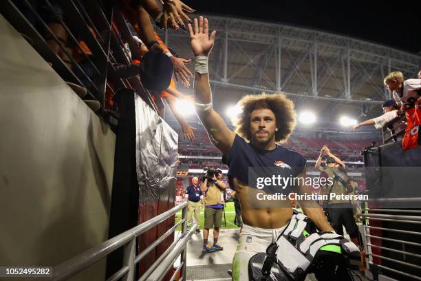 Runningback Phillip Lindsay of the Denver Broncos waves to fans as he leaves the field following the NFL game against the Arizona Cardinals at State...