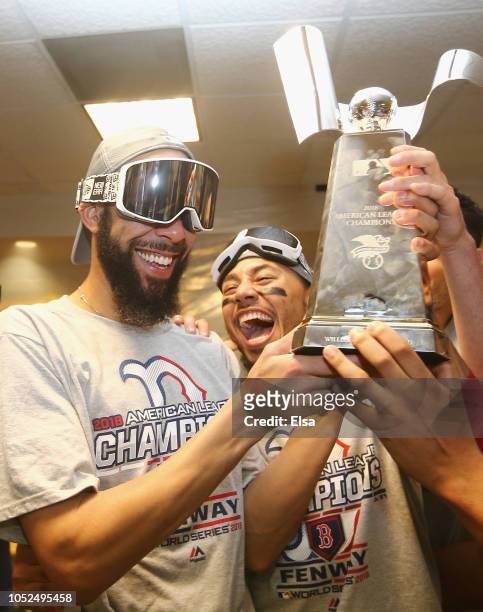 David Price and Mookie Betts of the Boston Red Sox celebrate with the William Harridge Trophy in the clubhouse after defeating the Houston Astros 4-1...